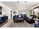 Spacious living room with modern furnishings, including comfortable sofa and an open layout with views into the kitchen at 9544 E Theia Dr, Mesa, AZ 85212