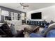 Bright living room featuring a large flat screen TV, modern furnishings, and stylish decor at 9544 E Theia Dr, Mesa, AZ 85212