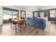Open-concept living and dining area featuring modern decor, wood floors, and a large sliding glass door at 9544 E Theia Dr, Mesa, AZ 85212