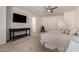 Spacious main bedroom featuring a TV, ensuite bathroom, and neutral-toned walls and flooring at 9544 E Theia Dr, Mesa, AZ 85212