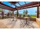 Inviting community outdoor lounge area with pergola, tables, and chairs, perfect for gathering and enjoying the outdoors at 9544 E Theia Dr, Mesa, AZ 85212