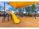 Community playground with yellow slide and climbing equipment under sunshades, providing a safe and enjoyable play area at 9544 E Theia Dr, Mesa, AZ 85212