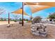 Community playground with sunshades, rock features, and wooden bench seating, surrounded by landscaping and neighborhood homes at 9544 E Theia Dr, Mesa, AZ 85212