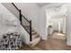 Modern staircase with black metal railing, carpeted steps, and a view into the bright entryway at 9544 E Theia Dr, Mesa, AZ 85212