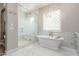 Bright bathroom with a standalone tub, glass shower, and elegant tile work at 9834 E Voltaire Dr, Scottsdale, AZ 85260