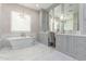Elegant bathroom featuring a standalone tub, double vanity, and sophisticated finishes at 9834 E Voltaire Dr, Scottsdale, AZ 85260