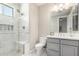 Bright, modern bathroom features sleek vanity, framed mirror, and a spacious shower at 9834 E Voltaire Dr, Scottsdale, AZ 85260