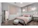 Bedroom featuring wainscoting, a light pink color scheme, and decorative mirror at 9834 E Voltaire Dr, Scottsdale, AZ 85260