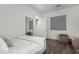 Bright bedroom showcasing a plush bed, chair and laminated wood flooring at 9834 E Voltaire Dr, Scottsdale, AZ 85260