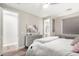 Relaxing bedroom featuring wood floors, a soft color palette, and access to the en-suite bathroom at 9834 E Voltaire Dr, Scottsdale, AZ 85260
