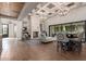 Elegant living room features hardwood floors, coffered ceilings, a fireplace, and large windows at 9834 E Voltaire Dr, Scottsdale, AZ 85260