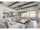 Spacious living room with hardwood floors and an open floor plan to the kitchen and backyard at 9834 E Voltaire Dr, Scottsdale, AZ 85260