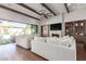 Cozy living room with beamed ceilings, fireplace, built-in cabinets, and backyard view at 9834 E Voltaire Dr, Scottsdale, AZ 85260
