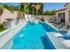 Outdoor swimming pool featuring a slide, water features and lounge chairs, ideal for relaxation at 9834 E Voltaire Dr, Scottsdale, AZ 85260