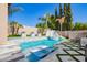 Backyard pool and spa area featuring modern white loungers, water feature and tropical landscaping at 9834 E Voltaire Dr, Scottsdale, AZ 85260