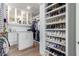 Spacious walk-in closet with custom shelving and ample storage for clothes and shoes at 9834 E Voltaire Dr, Scottsdale, AZ 85260