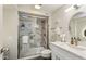 Bathroom featuring a glass shower with marble tiling and a sleek vanity offers a spa-like experience at 9926 W Lancaster Dr, Sun City, AZ 85351