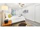 Bright bedroom featuring hardwood floors, a sliding glass door, and neutral decor at 9926 W Lancaster Dr, Sun City, AZ 85351
