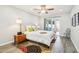 Bright bedroom with a ceiling fan, light hardwood floors, and sliding glass doors to the outside patio at 9926 W Lancaster Dr, Sun City, AZ 85351