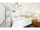 Bright bedroom with a ceiling fan, light hardwood floors, and a neutral color scheme at 9926 W Lancaster Dr, Sun City, AZ 85351
