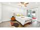 Comfortable bedroom with hardwood floors and a sliding glass door to the backyard at 9926 W Lancaster Dr, Sun City, AZ 85351