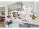 Bright kitchen featuring white cabinets, stainless steel appliances, and a stylish marble countertop at 9926 W Lancaster Dr, Sun City, AZ 85351