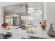 Updated kitchen features stainless appliances, white cabinetry and marble countertop at 9926 W Lancaster Dr, Sun City, AZ 85351
