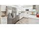 Modern kitchen with stainless steel appliances and white cabinets at 9926 W Lancaster Dr, Sun City, AZ 85351