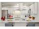 Updated kitchen with modern white cabinets, stainless steel appliances, and stylish countertops at 9926 W Lancaster Dr, Sun City, AZ 85351