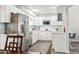 Well-lit kitchen featuring stainless steel appliances, modern white cabinets, and updated lighting at 9926 W Lancaster Dr, Sun City, AZ 85351