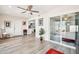 Bright living room features hardwood floors, a ceiling fan, and sliding glass doors at 9926 W Lancaster Dr, Sun City, AZ 85351