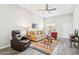 Cozy living room features hardwood floors, a ceiling fan, and ample seating at 9926 W Lancaster Dr, Sun City, AZ 85351