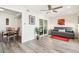 Open floor plan living room with dining area, hardwood floors and natural light at 9926 W Lancaster Dr, Sun City, AZ 85351