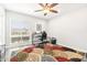 Bright office with a ceiling fan, light hardwood floors, and a large window at 9926 W Lancaster Dr, Sun City, AZ 85351