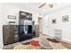 Bright office with a ceiling fan, light hardwood floors, and built-in shelving at 9926 W Lancaster Dr, Sun City, AZ 85351