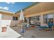 Covered patio featuring a dining set and lounge chair, ideal for outdoor living at 9926 W Lancaster Dr, Sun City, AZ 85351