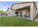 Inviting backyard with a covered patio, outdoor furniture, and low-maintenance artificial grass at 1049 S Exeter St, Chandler, AZ 85286