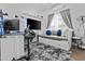Comfortable bedroom with a large TV, gaming setup, and soft gray carpet at 1049 S Exeter St, Chandler, AZ 85286