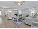 Bright living room features wood floors, neutral furniture, and a crystal ceiling fan at 1049 S Exeter St, Chandler, AZ 85286
