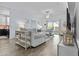 Bright living room features wood floors, neutral furniture, and a sliding glass door to the outdoor space at 1049 S Exeter St, Chandler, AZ 85286