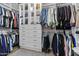 Walk-in closet with organized shelving, drawers, and hanging racks for ample storage at 1049 S Exeter St, Chandler, AZ 85286