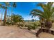 Scenic view of the golf course featuring palm trees, manicured fairways, and a picturesque lake at 11018 W Boswell Blvd, Sun City, AZ 85373