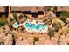 Aerial view of a beautiful community pool area surrounded by lush landscaping and seating at 11500 E Cochise Dr # 1094, Scottsdale, AZ 85259