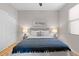 Comfortable bedroom with a ceiling fan, neutral walls, stylish lamps, and a cozy-looking bed with a blue blanket at 11500 E Cochise Dr # 1094, Scottsdale, AZ 85259