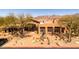 Beautiful desert home featuring mature trees, xeriscaping and a prominent statue in the front yard at 11500 E Cochise Dr # 1094, Scottsdale, AZ 85259