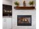 Modern fireplace with stone surround and wooden mantle at 11500 E Cochise Dr # 1094, Scottsdale, AZ 85259