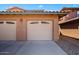 Attached two-car garage with a light-colored door and paved driveway at 11500 E Cochise Dr # 1094, Scottsdale, AZ 85259
