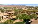 Aerial view of a manicured green space surrounded by residential buildings and mature trees at 11500 E Cochise Dr # 1094, Scottsdale, AZ 85259