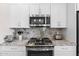 Well-equipped kitchen with granite countertops, stainless steel appliances, and white cabinets at 11500 E Cochise Dr # 1094, Scottsdale, AZ 85259