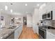 Spacious open kitchen with granite countertops, stainless steel appliances, and hardwood floors at 11500 E Cochise Dr # 1094, Scottsdale, AZ 85259